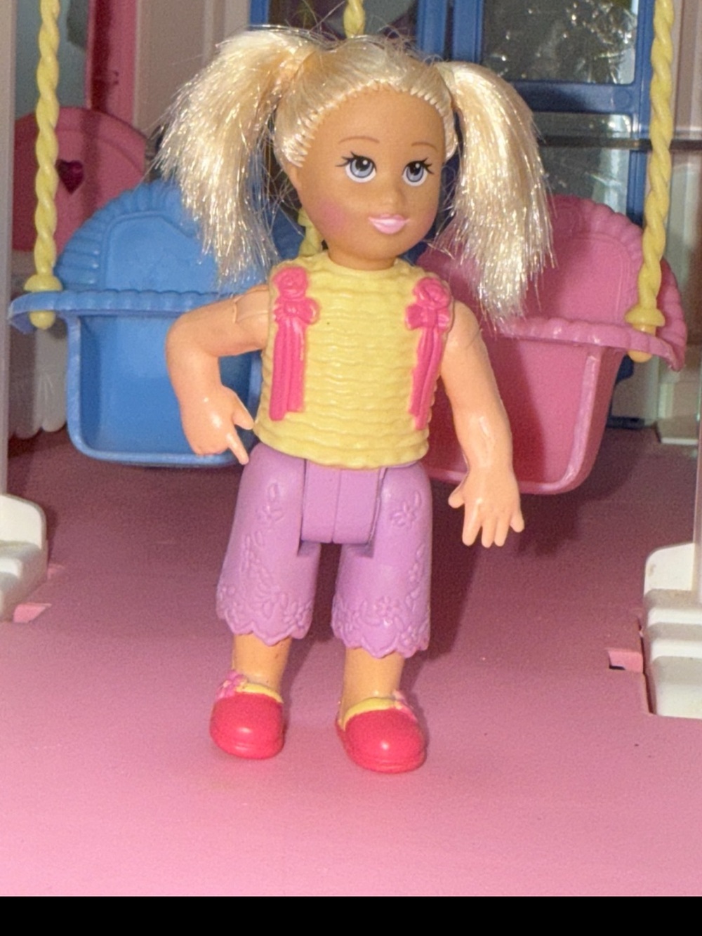 Little girl doll with blonde pigtails and pink outfit loving family dollhouse